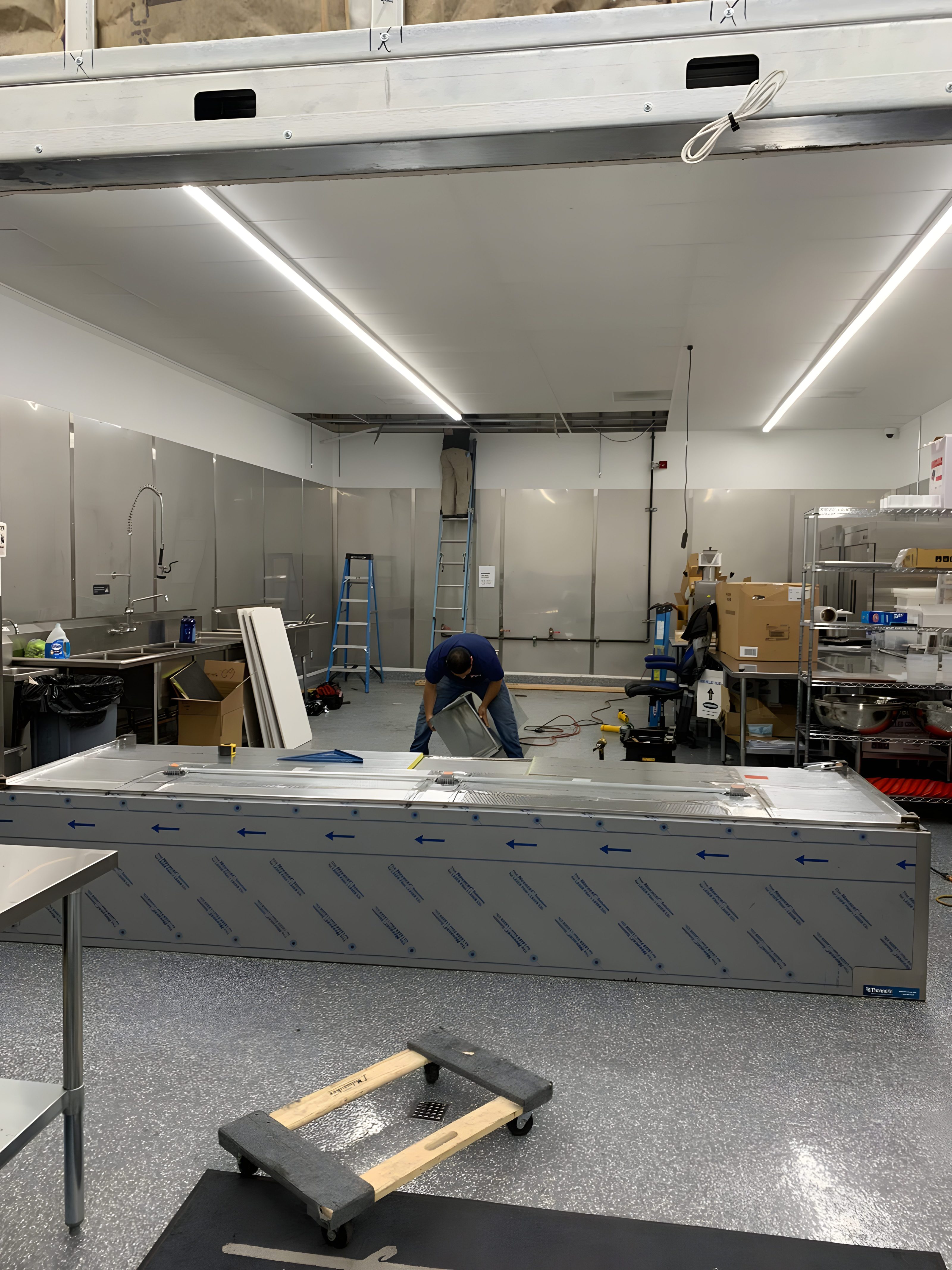 A kitchen build-out with the new hood crated on site