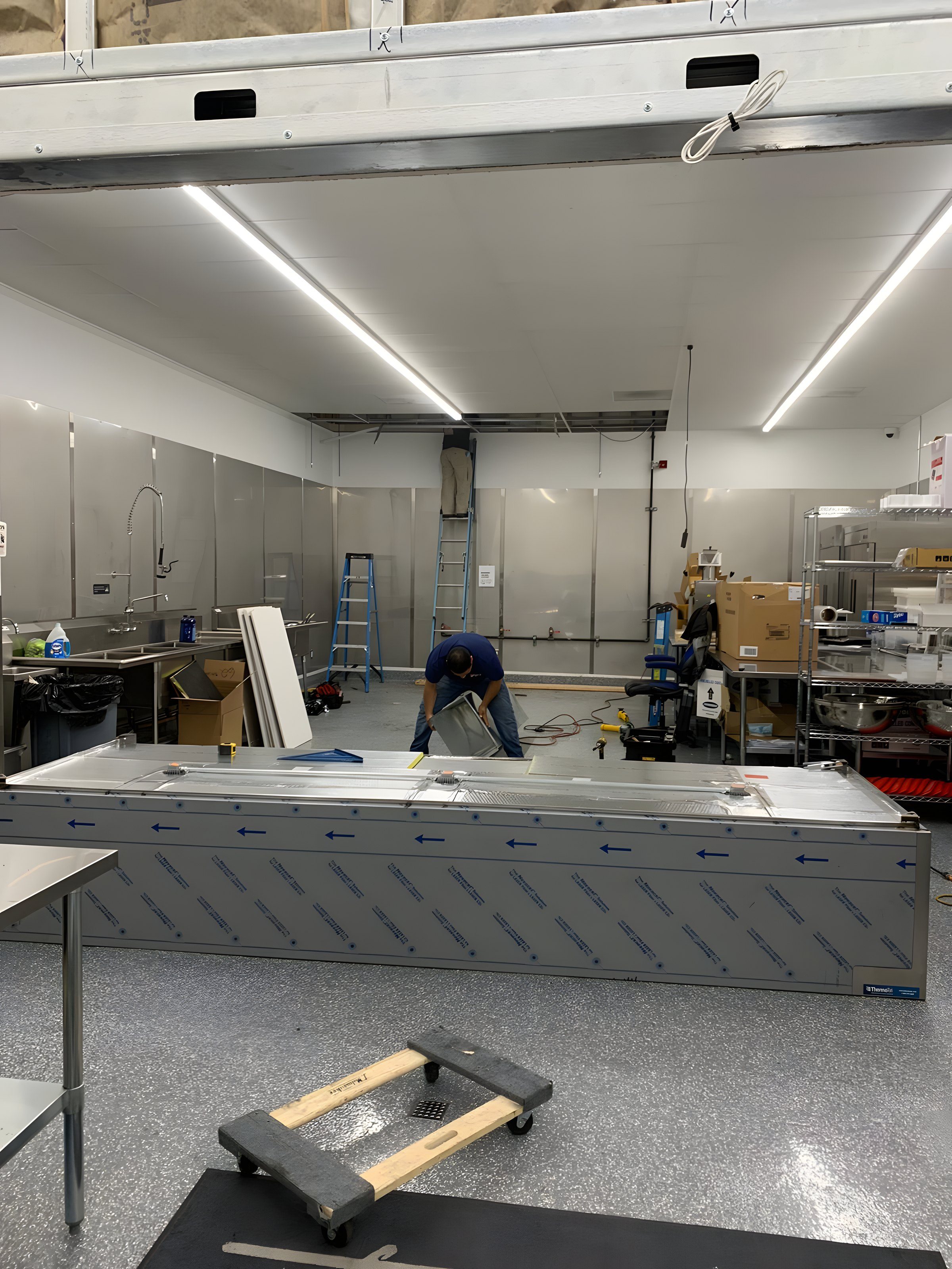 A kitchen build-out with the new hood crated on site